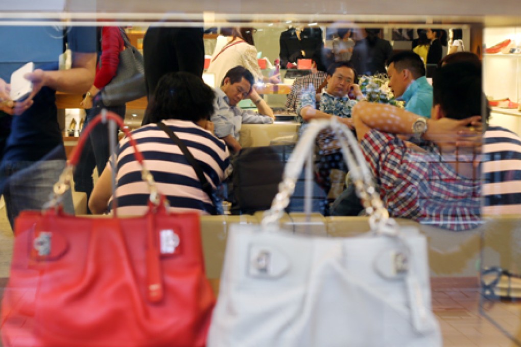 Chinese tourists take a break in a luxury store in Causeway Bay. Photo: Sam Tsang