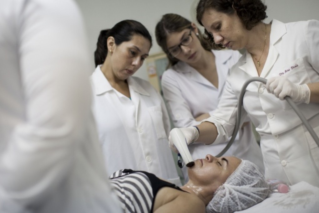 A woman receives a free aesthetic treatment in Rio de Janeiro, Brazil. Photo: AP