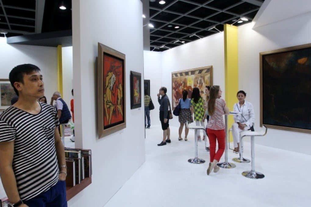 Visitors look at artworks during Art Basel at Hong Kong Convention and Exhibition Centre (HKCEC) in Wan Chai. Photo: Jonathan Wong
