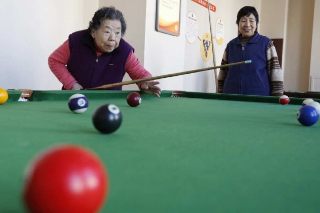 Residents of a nursing home in Beijing play billiards during their recreational time on March 1, 2013. Photo: Reuters
