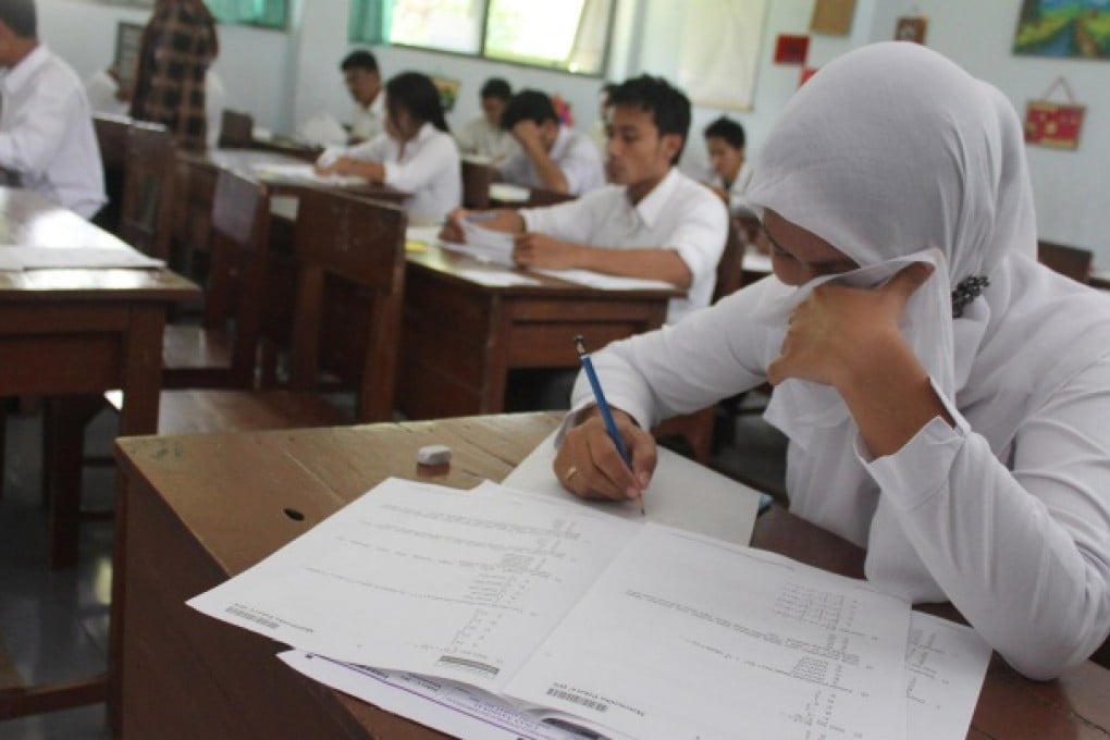 Indonesian high school pupils sit for national exams in Malang in eastern Java. Cheating is rife in schools, critics claim. Photo: AFP