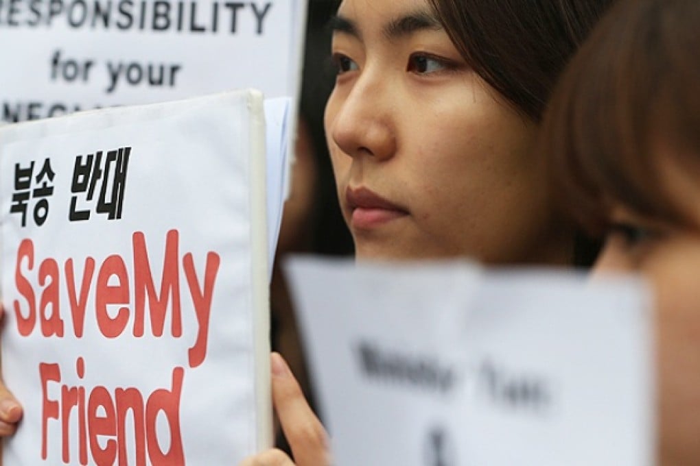 Human rights activists protest outside the foreign ministry in Seoul. Photo: AFP