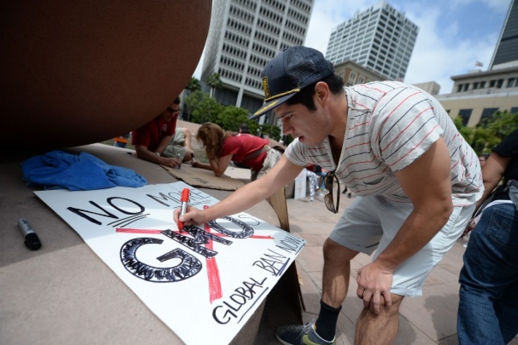 A protestor makes a sign for a May 25 protest against chemical giant Monsanto in Los Angeles. The discovery of an unapproved strain of genetically modified wheat has revived concerns about GM products. Photo: AFP