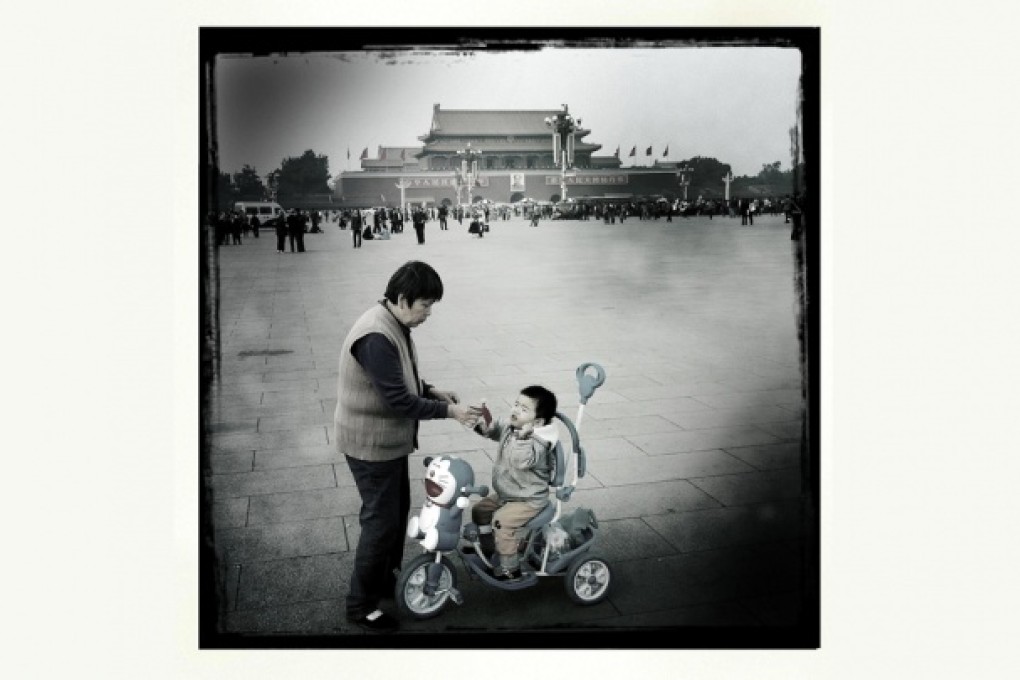 An elderly woman gives her grandson a sausage in Tiananmen Square. While the mainland's elderly population is the fastest-growing in the world, the younger population is in decline. Photo: Simon Song