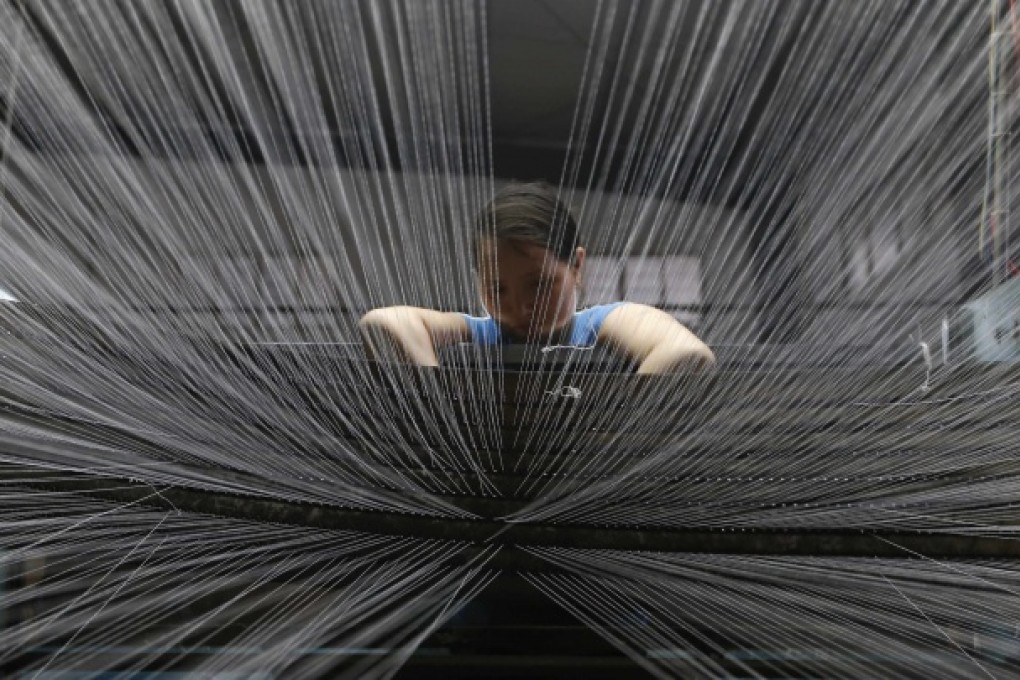 A textile worker at a factory in Linhai, Zhejiang province. Photo: Reuters