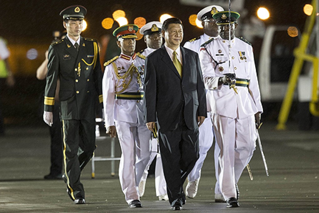 President Xi Jinping (centre) arrives in Port of Spain on Friday. Photo: AFP