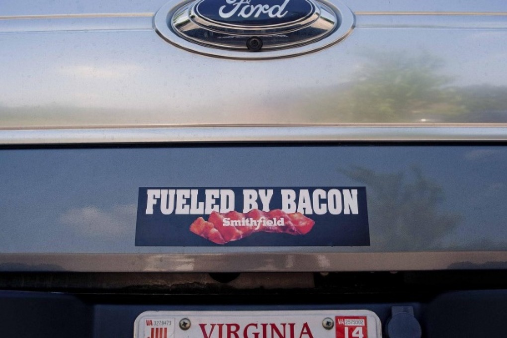 A bacon bumper sticker leaves no doubt about what is the driving force in the town. Photo: Reuters