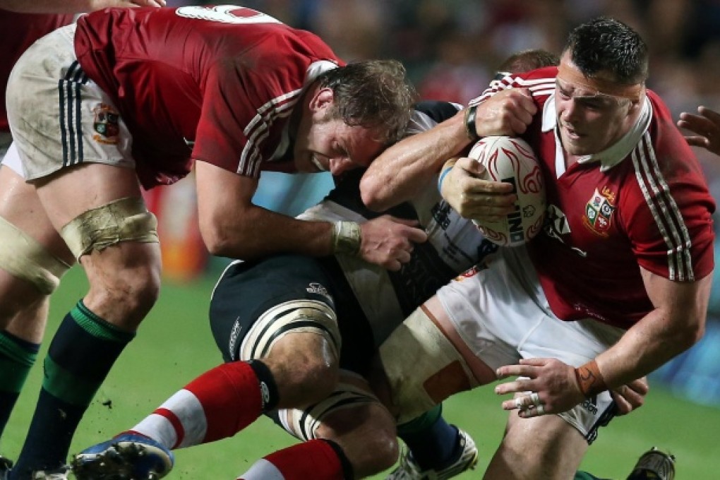Cian Healy takes plenty of stopping during last night's encounter with the Barbarians at Hong Kong Stadium. The Lions ran in eight tries in a 59-8 victory. Photo: Sam Tsang