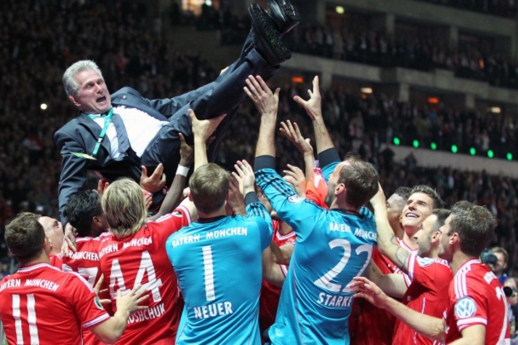 Jubilant Bayern Munich players hold outgoing coach Jupp Heynckes aloft as they celebrate victory against VfB Stuttgart in the German Cup final in Berlin. Photo: Xinhua