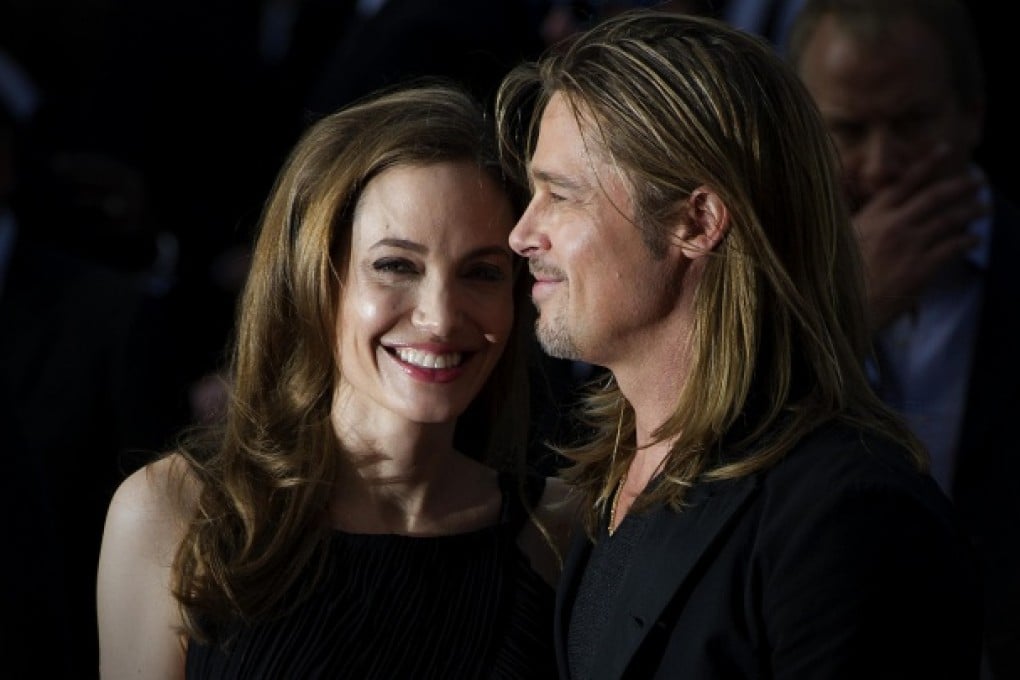 Angelina Jolie and Brad Pitt smile for the cameras on the red carpet in London as they attend the world premiere of Pitt's new movie World War Z. Photo: AFP