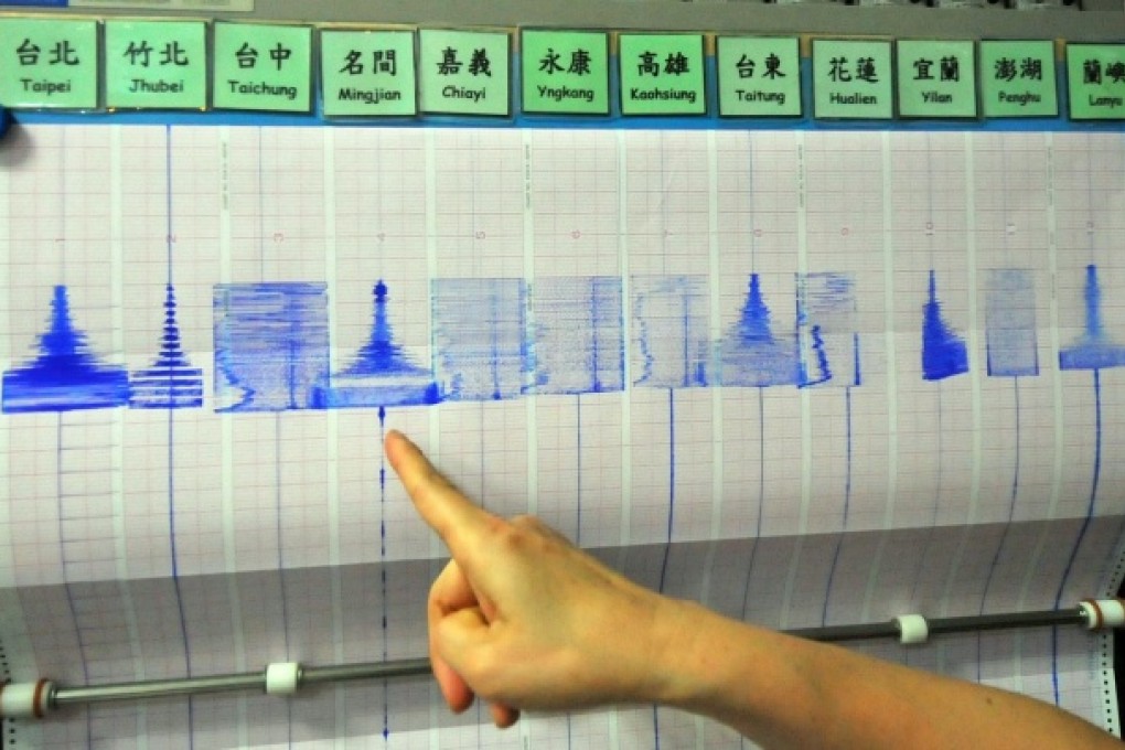 An official at the seismology centre in Taipei points to a chart after the 6.3-magnitude earthquake shook buildings in the city. Photo: AFP