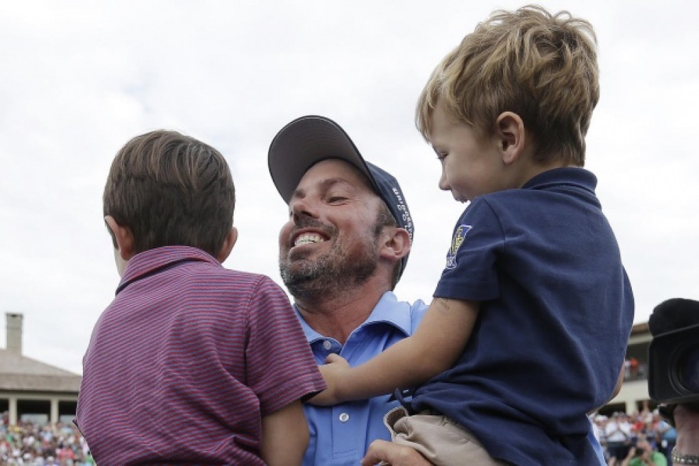 Matt Kuchar celebrates with his children, Cameron and Carson, after winning the Memorial golf tournament.