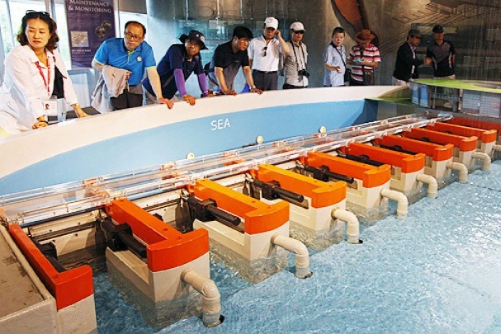 Tourists watch a demonstration of how the Marina Barrage dam works in Singapore. Singapore is a hub for water technology because of its own concerns about water security.  Photo: Reuters