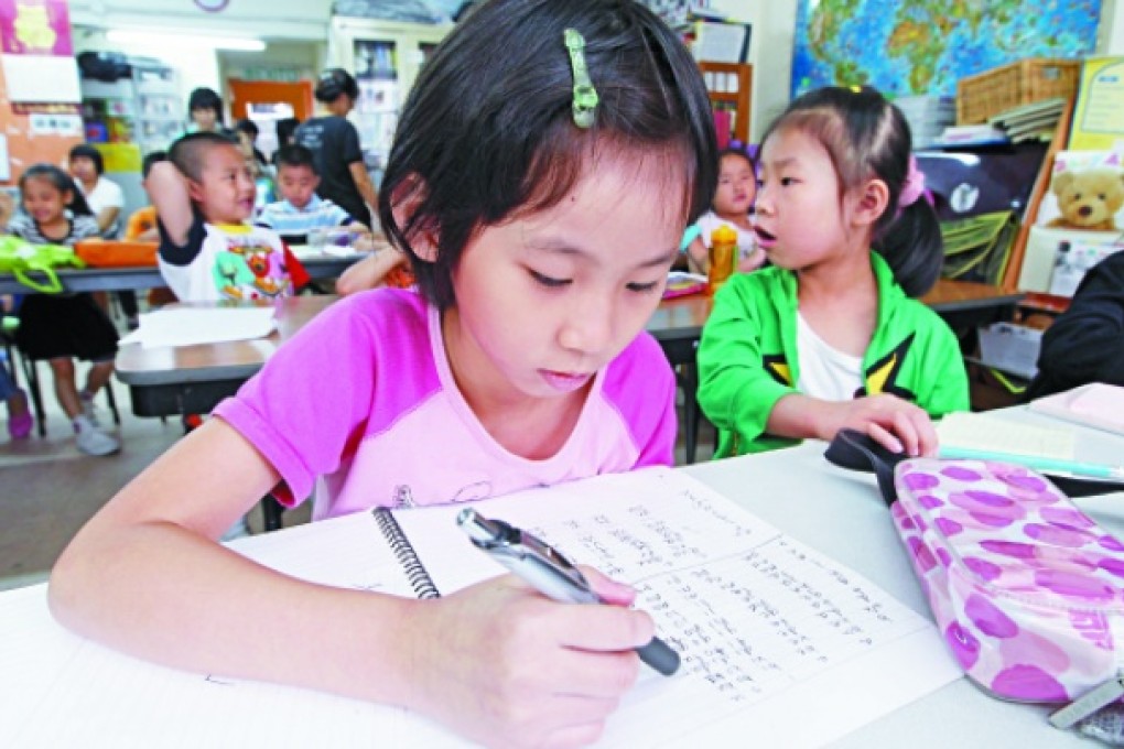 Coco Ko Yee-tung learns English at the Soco childcare centre in Sham Shui Po. The reason children appear to be better learners than adults may be down to their more encouraging environment. Photo: Edward Wong