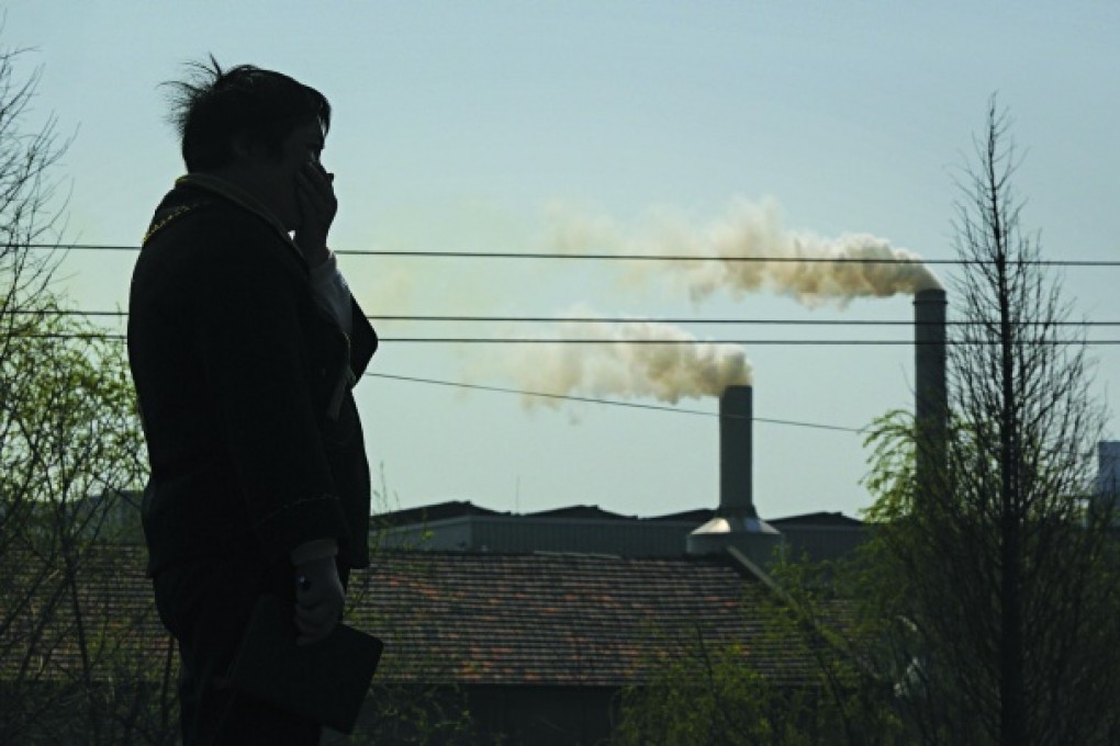 Wei Dongying covers her mouth near a chemical factory in the village of Wuli, Zhejiang province. Photos: Red Door News Hong Kong; Wei Dongying; Greenpeace