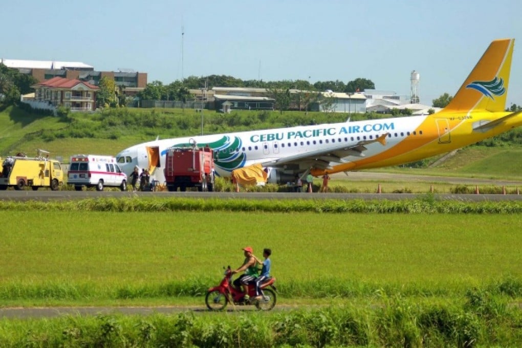 The plane came to rest nose down after overshooting the runway at Davao International Airport with 165 passengers on board. Photo: EPA