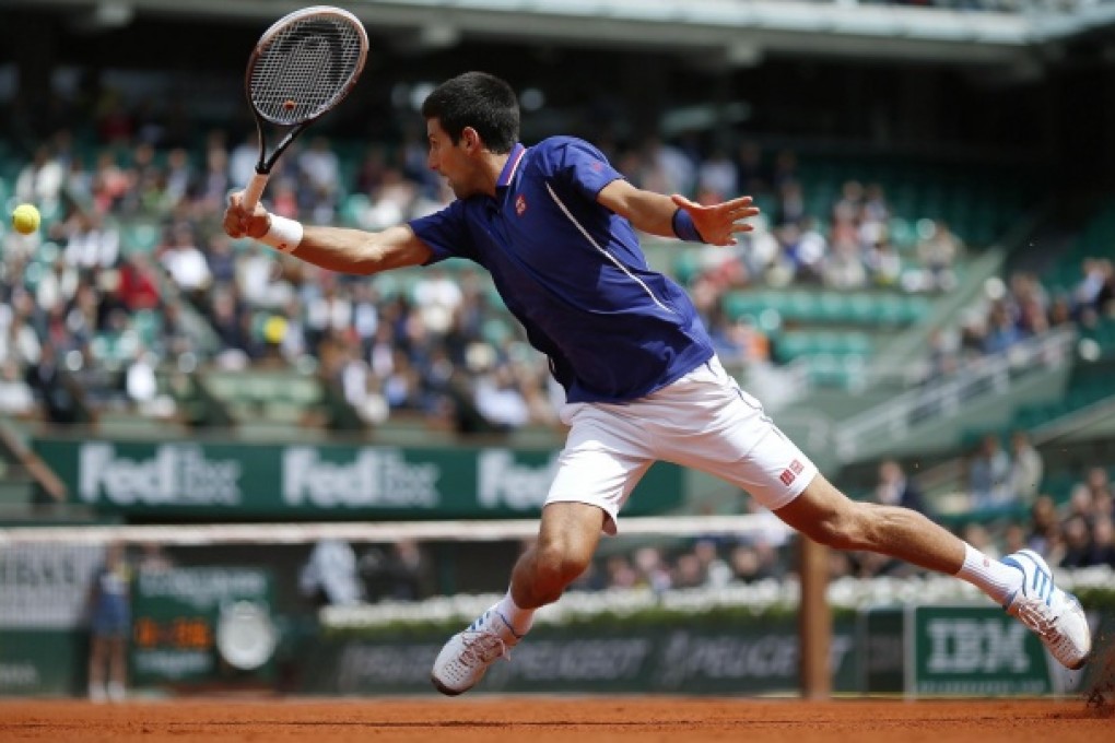 Novak Djokovic lifts off as he returns to Philipp Kohlschreiber during their fourth-round match at Roland Garros yesterday. Photo: AFP