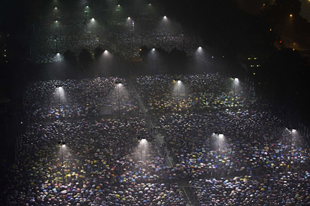 Tens of thousands of people gather for the June 4 candlelight vigil  under heavy rain in Victoria Park on Tuesday night. Photo: Reuters