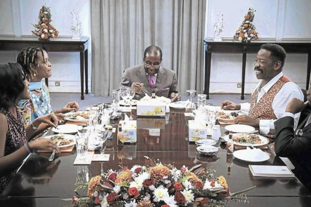 Robert Mugabe plays happy families with interviewer Dali Tambo.