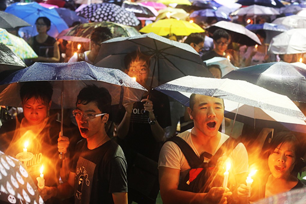 Attendees of the vigil at Hong Kong's Victoria Park sing songs of protest. Photo: Sam Tsang