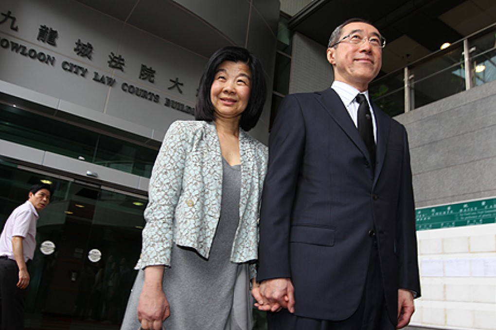 Henry Tang and his wife Lisa Kuo Yu-chin leave Kowloon City Court after her appearance to answer charges over illegal structures at her Kowloon Tong home. Photo: Felix Wong
