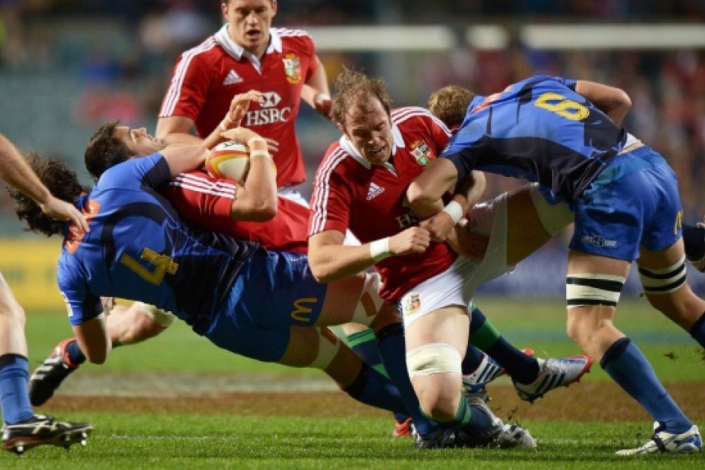 The Lions' Conor Murray is caught in possession in a high tackle during the tourists' 69-17 victory over the Western Force yesterday. Photos: AFP