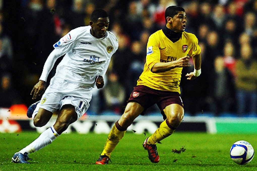Arsenal's Denilson (right) plays in Leeds in 2011. He will leave the club at the end of June. Photo: AFP
