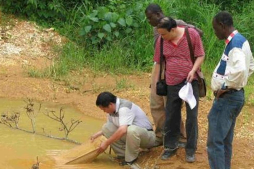 A Chinese man inspects ore at a mine in Ghana. Photo: SCMP