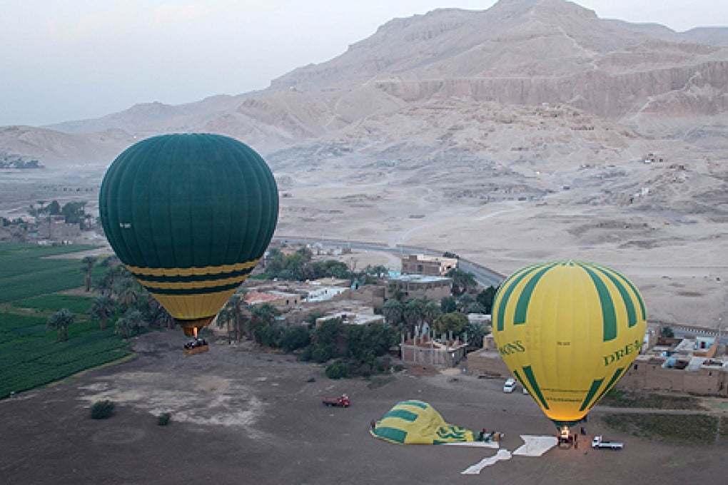 The hot air balloon (left) that later crashed is seen taking off from Luxor in February. Photo: AFP