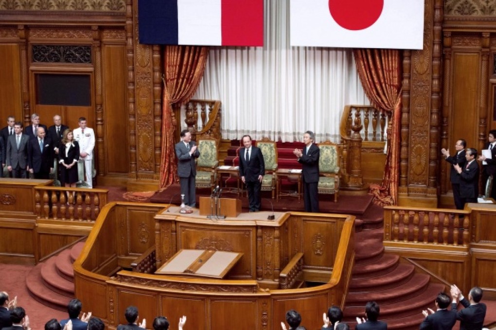 French President Francois Hollande is applauded as he prepares to deliver a speech to the parliament in Tokyo. Photo: AFP