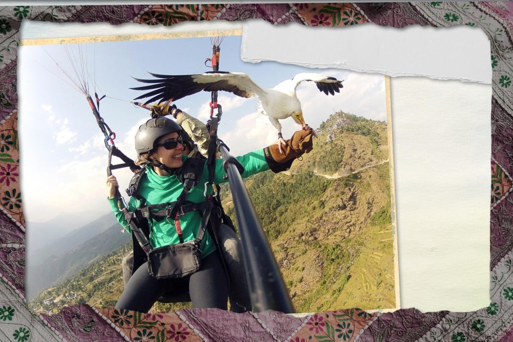 A vulture named Kevin takes a snack from the author's hand as she paraglides in Nepal. Photo: Parahawking/Phillippa Stewart