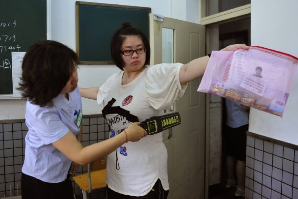 A student goes through a security check as she enters the classroom to take the National College Entrance Exam in Shenyang. Photo: Reuters