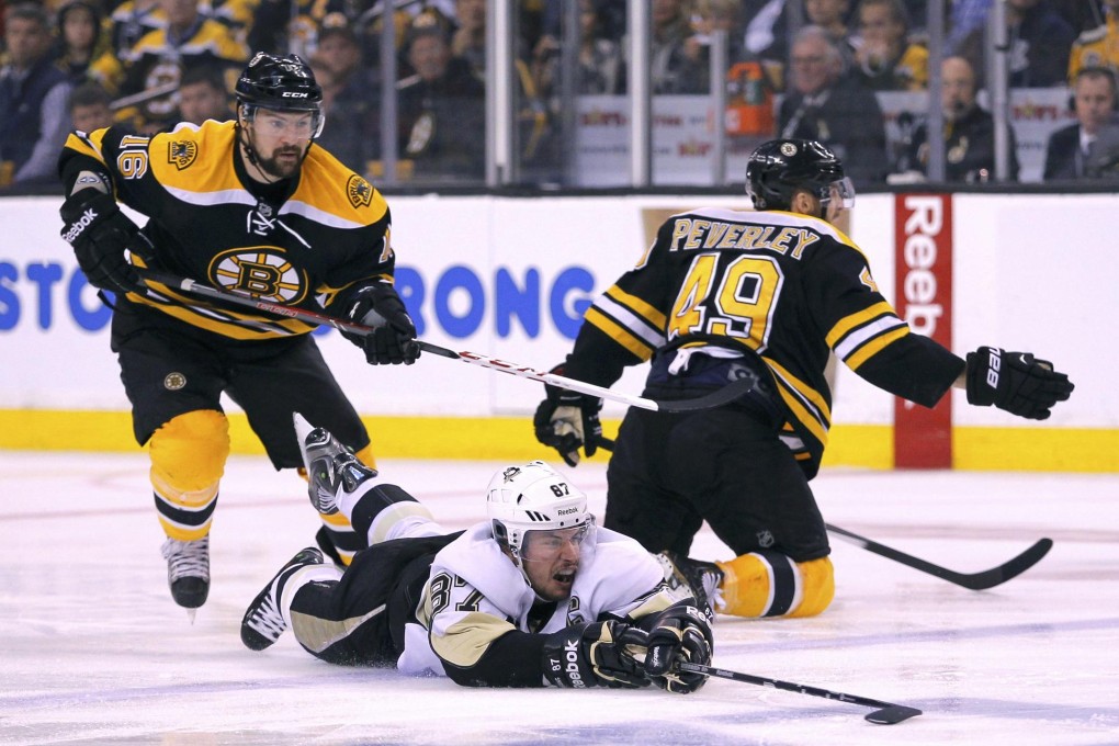 The Pittsburgh Penguins' Sidney Crosby falls to the ice after a hit from the Bruins' Rich Peverley.Photo: Reuters