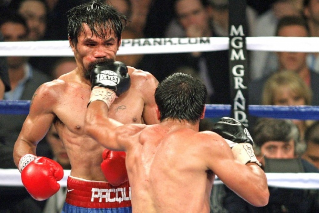 Manny Pacquiao takes a punch from Juan Manuel Marquez.