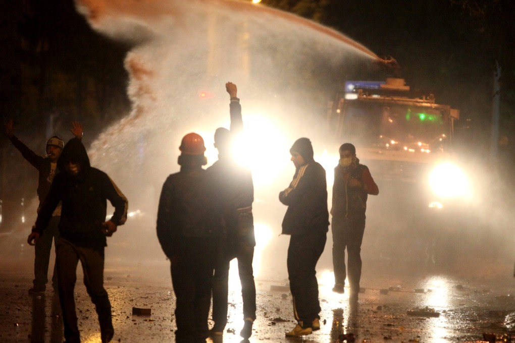 Riot police fire water cannons at anti-government protesters in central Ankara. Photo: Reuters