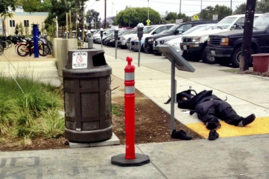The body of the gunman involved in a shooting spree lies on a footpath outside Santa Monica College. Photo: Reuters
