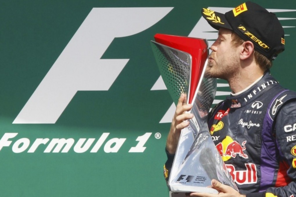 Red Bull's Sebastian Vettel kisses his F1 trophy. Photo: Reuters