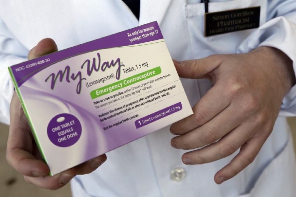 A pharmacist holds a generic emergency contraceptive, also called the morning-after pill. Photo: AP