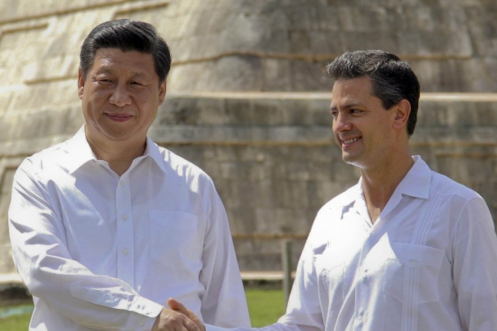 China's President Xi Jinping shakes hands with Mexico's President Enrique Pena Nieto as they visit the archaeological site of Chichen itza, State of Yucatan. Photo: AFP