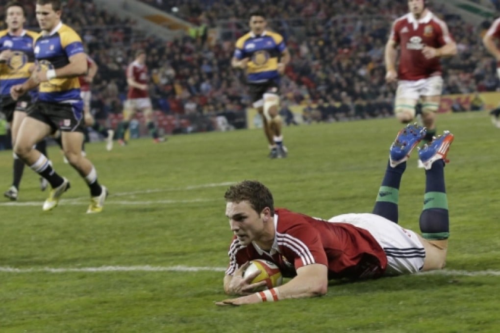 George North slides in to score one of his two tries in a comprehensive win over the New South Wales & Queensland Country team. Photo: AP