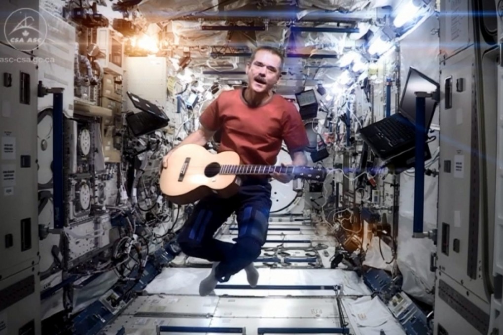 Hadfield performs David Bowie's Space Oddity. Photo: EPA