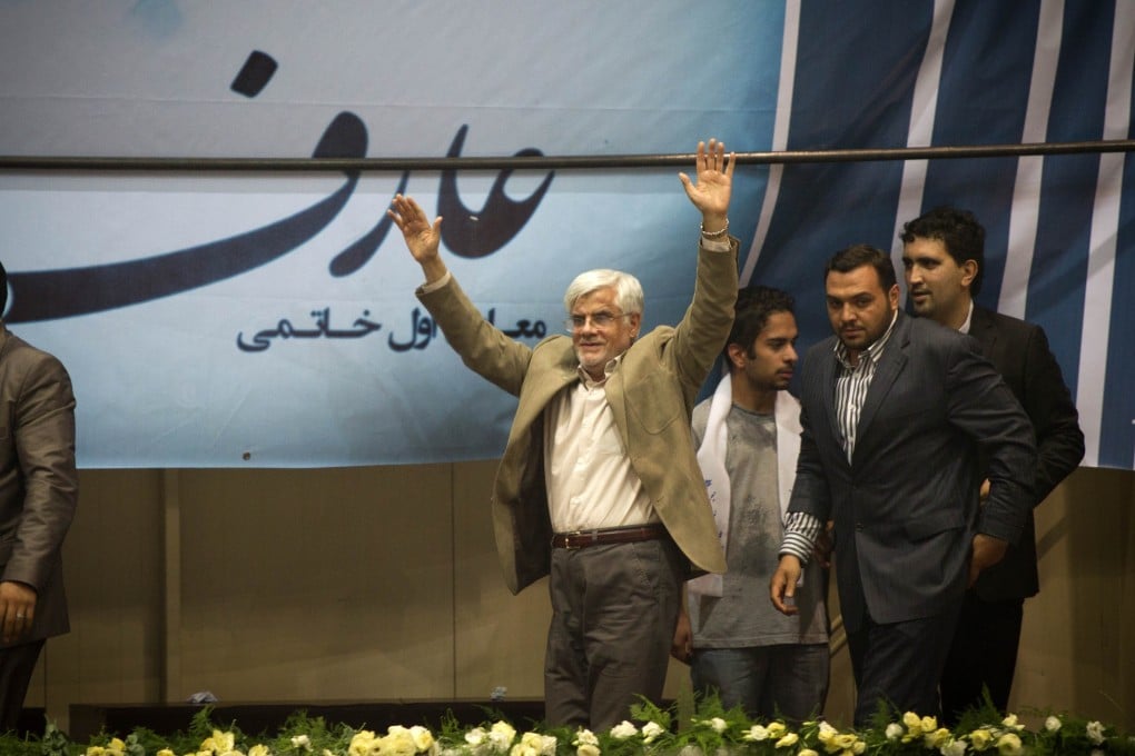 Iranian reformist presidential candidate Mohammad-Reza Aref (left) waves to supporters during his campaign rally in Tehran in Iran. Photo: Xinhua.