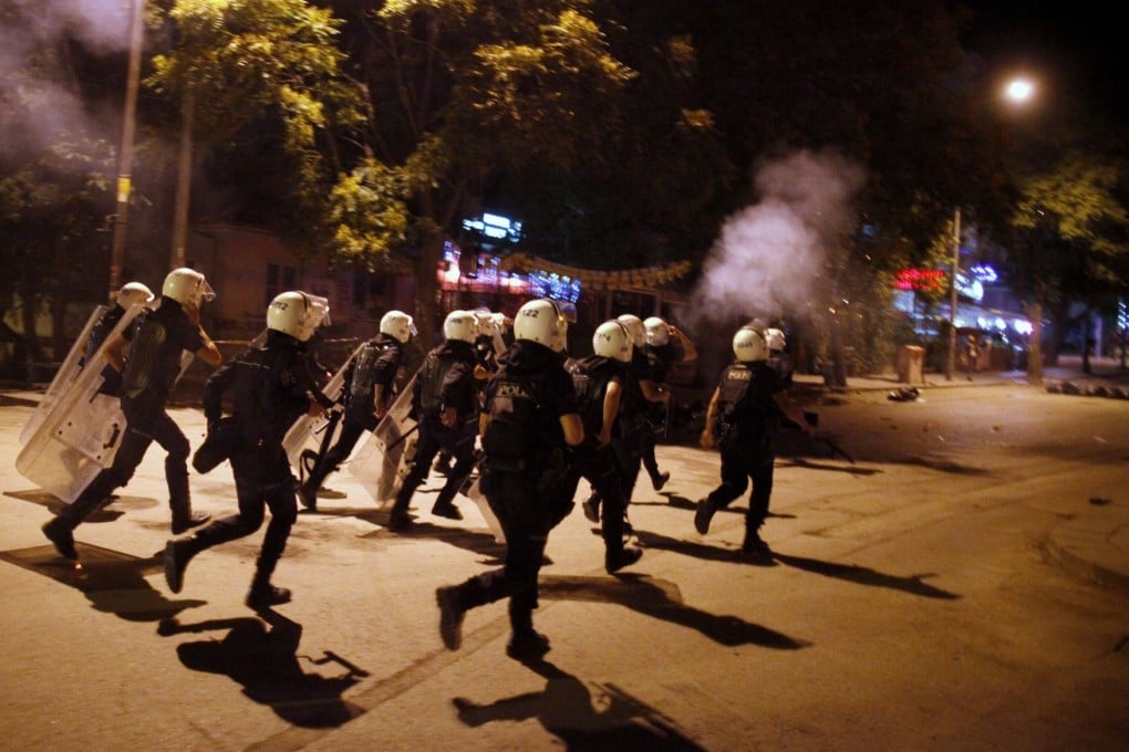 Turkish riot police chase anti-government protesters on Tuesday. Photo: Reuters