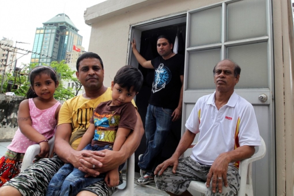 For Habibur Rahman (in yellow) and his children, John (in black), and Mohamed Sultan (in white), falling ill here will leave them reeling from their medical bills. Photo: May Tse