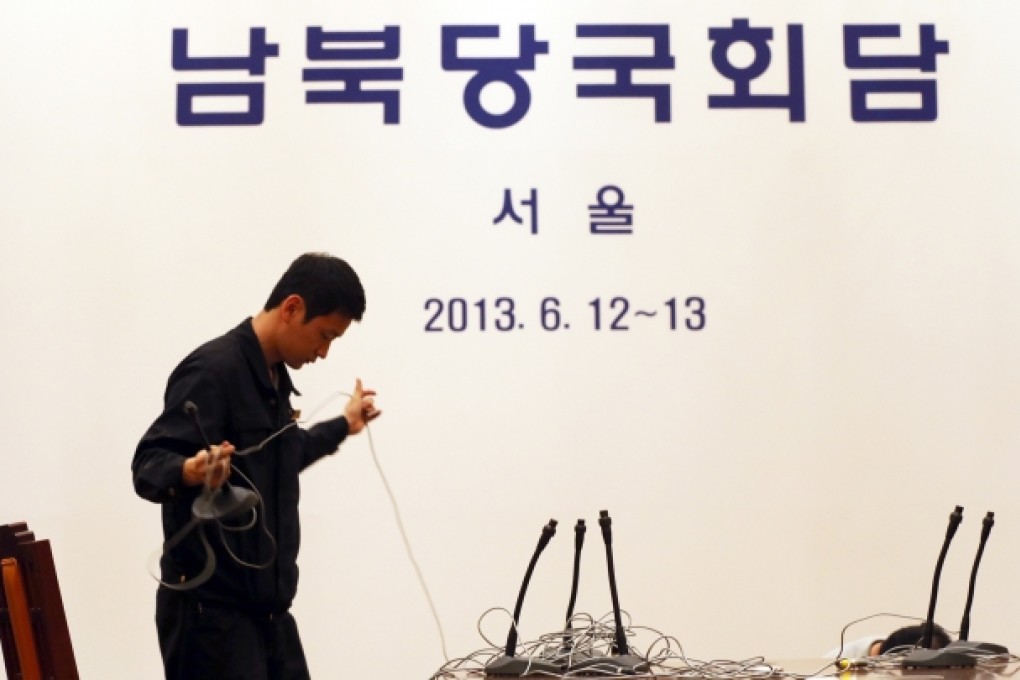 A worker takes microphone system apart at the venue for an inter-Korean governments meeting at a hotel in Seoul. Planned high-level talks between South and North Korean were scrapped on Tuesday. Photo: Reuters