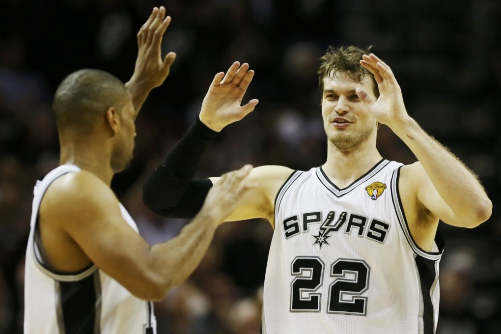 San Antonio Spurs' Tiago Splitter (right) celebrates with teammate Gary Neal against the Miami Heat in the third quarter during Game 3 of their NBA Finals basketball playoff in San Antonio, Texas. Photo: Reuters