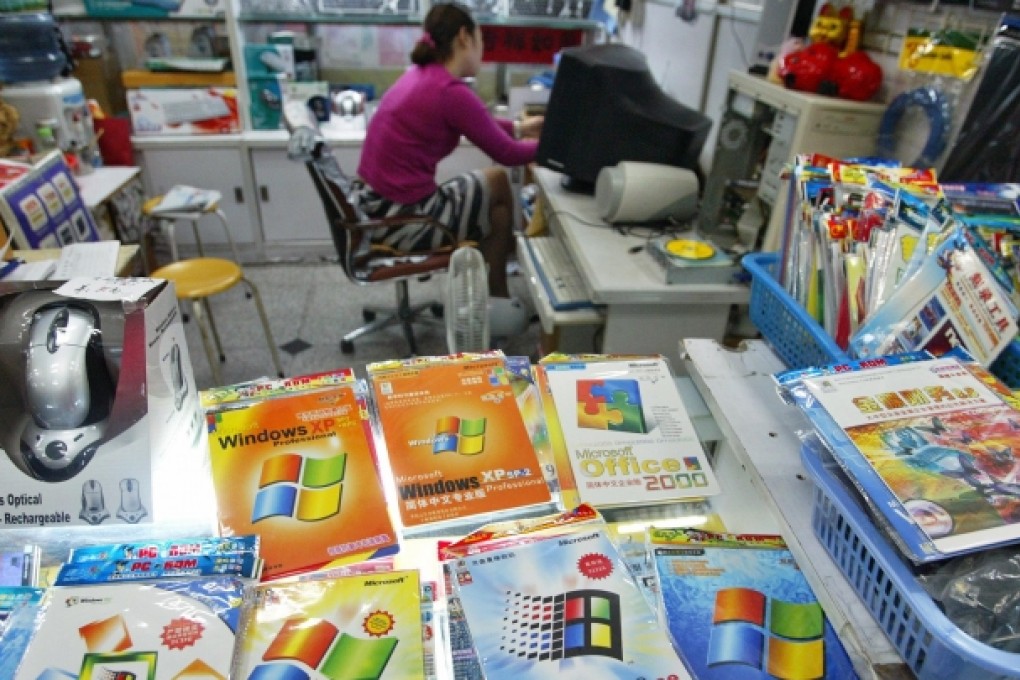A woman sits in a shop where pirated software is displayed for sale in Shanghai. Photo: Reuters