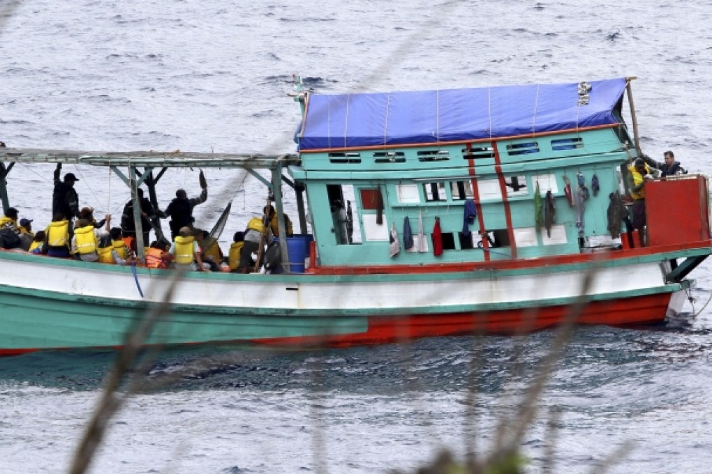 A fishing boat carrying Vietnamese asylum seekers nears the shore of Australia's Christmas Island in April 2013. Photo: AP