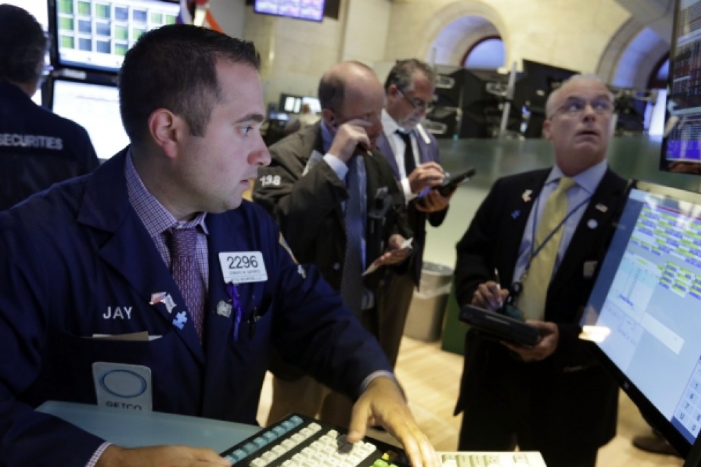 Genaro Saporito (left) works at the post that handles Dole Foods, on the floor of the New York Stock Exchange. Dole’s chief executive and chairman and family offered to buy the business on Tuesday. Photo: AP