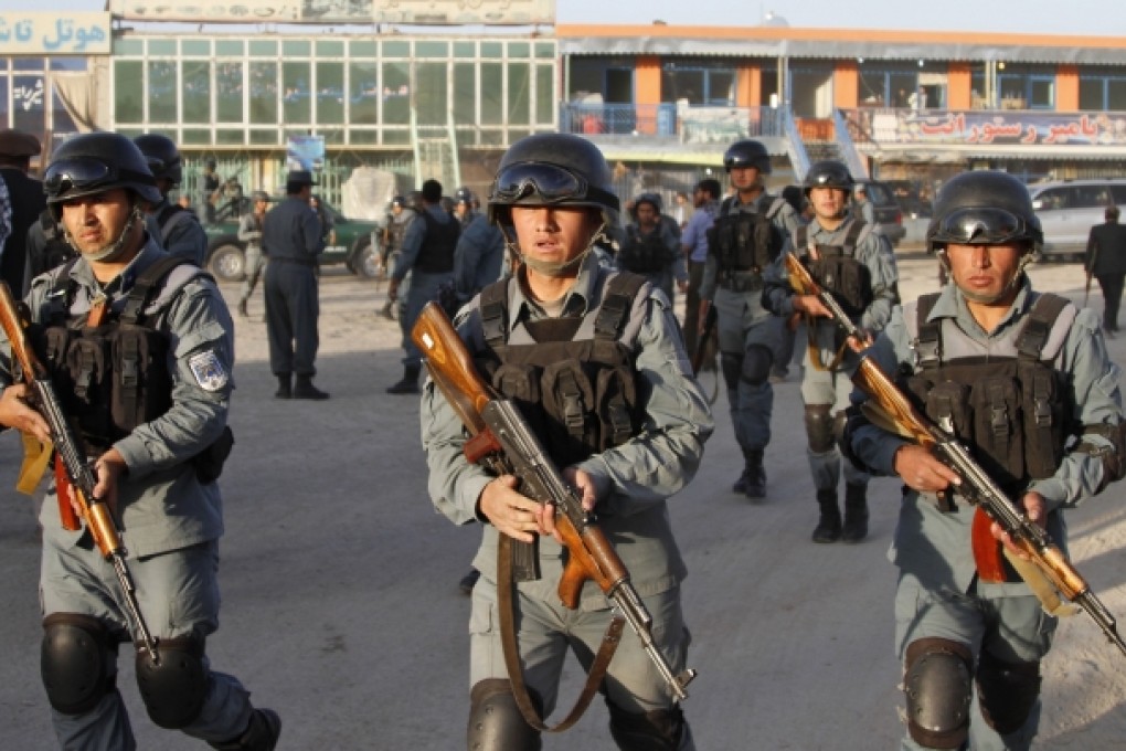 Afghan policemen move around near Kabul airport, Afghanistan. Photo: AP